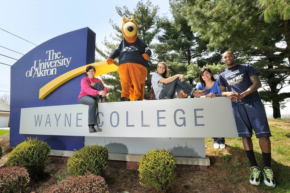 Wayne College students and Zippy pose for a photo atop the Wayne College sign